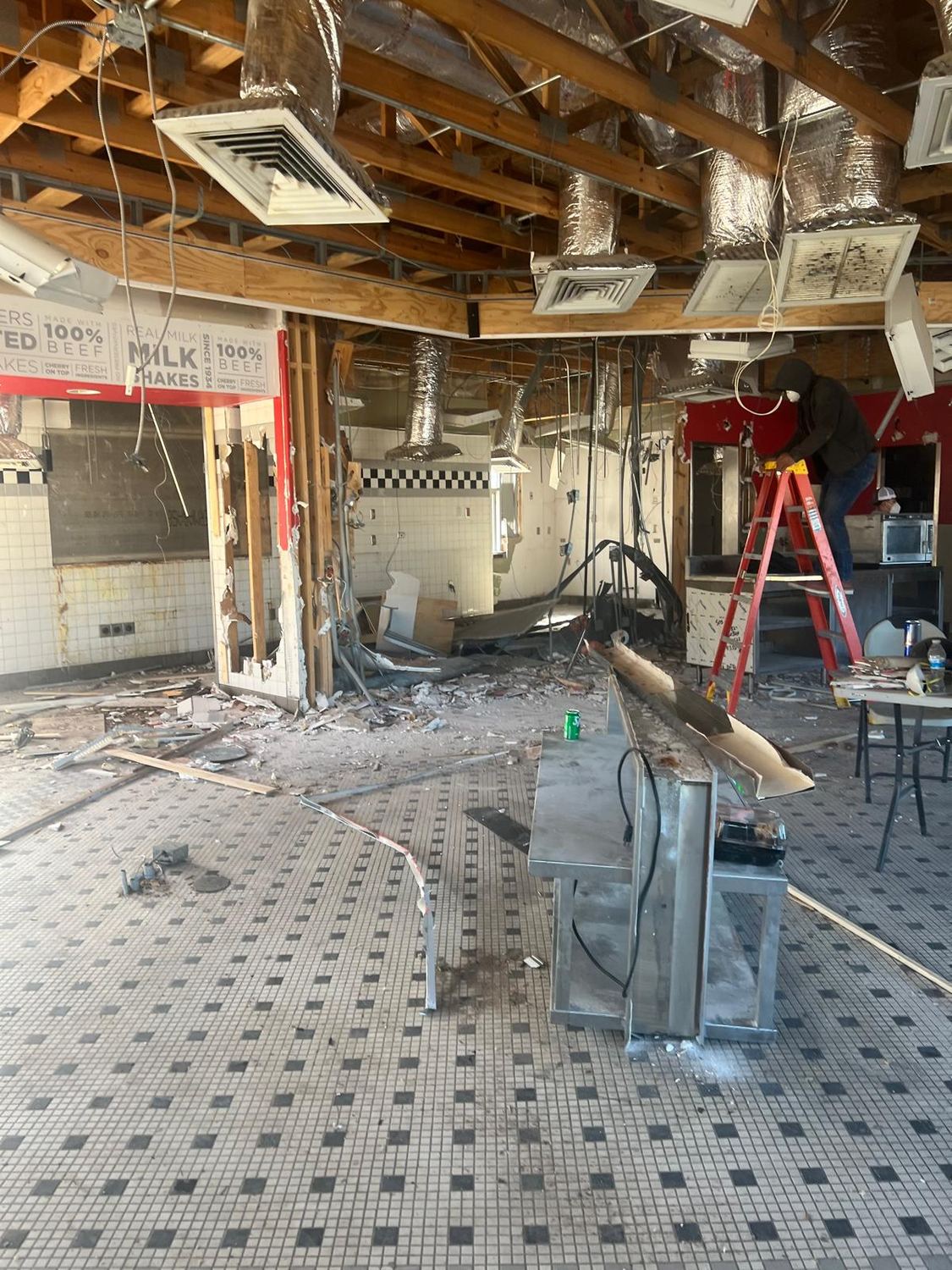 Interior stripped to the joists during demolition, ceiling removed and tile floor exposed
