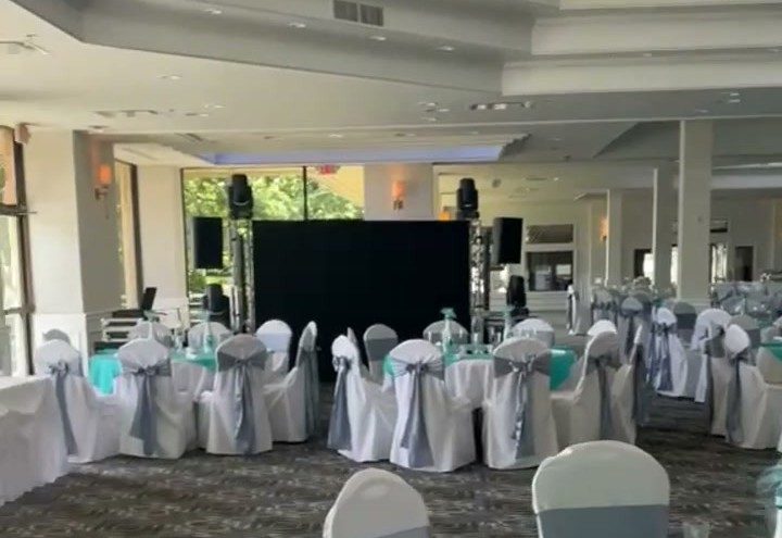 The finished event space set for service, banquet tables under the clerestory windows